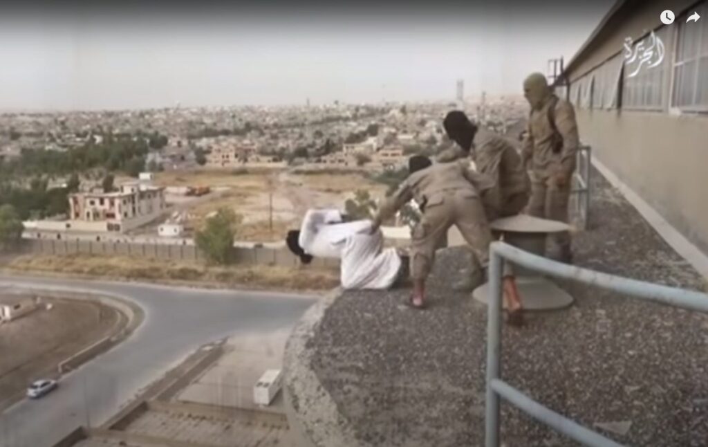 Man earing white  on his knees about to be thrown off a great height